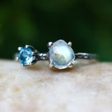 Faceted moonstone ring in silver bezel setting and blue topaz on the side with sterling silver band - Metal Studio Jewelry