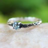 Blue topaz ring in silver bezel and prongs setting on sterling silver oxidized hard texture band - Metal Studio Jewelry