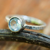 Round faceted blue topaz ring in silver bezel setting with sterling silver texture design band - Metal Studio Jewelry