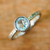 Round faceted blue topaz ring in silver bezel setting with sterling silver texture design band - Metal Studio Jewelry