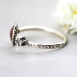 Round ruby ring in bezel setting with round blue topaz on sterling silver oxidized texture band - Metal Studio Jewelry