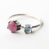 Faceted pink ruby ring in silver prongs setting and tiny moonstone