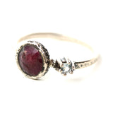 Round ruby ring in bezel setting with round blue topaz on sterling silver oxidized texture band - Metal Studio Jewelry