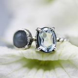 Oval faceted blue topaz ring in silver prongs setting and tiny moonstone on the side with sterling silver twist design band - Metal Studio Jewelry