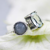 Oval faceted blue topaz ring in silver prongs setting and tiny moonstone on the side with sterling silver twist design band - Metal Studio Jewelry