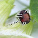 Oval Garnet ring in silver bezel and double prongs setting in silver twist design oxidized band - Metal Studio Jewelry