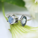 Marquis faceted Swiss blue topaz ring in silver bezel setting and moonstone on the side with sterling silver twist design band - Metal Studio Jewelry