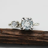 Round faceted blue topaz ring in silverr bezel and double prongs setting and moonstone on the side - Metal Studio Jewelry