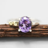 Oval faceted Amethyst ring in silver bezel and prongs setting and brass beads on the side with sterling silver texture band - Metal Studio Jewelry
