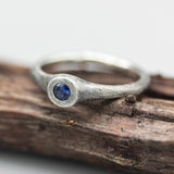 Sterling silver brush texture oxidized ring with tiny round faceted blue sapphire in silver bazel setting - Metal Studio Jewelry