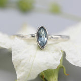 Marquise shape blue topaz ring in silver bezel setting with sterling silver texture band