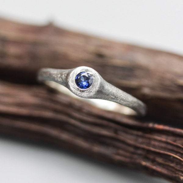 Sterling silver brush texture oxidized ring with tiny round faceted blue sapphire in silver bazel setting - Metal Studio Jewelry