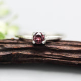 Tiny round garnet ring in prongs setting with sterling silver scratch texture band