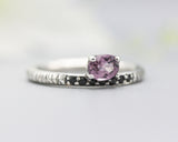 Oval faceted pink tourmaline ring in prongs setting with tiny black spinel on sterling silver oxidized line texture design band
