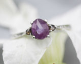Deep pink sapphire ring in prongs setting with tiny champagne diamonds side set gems with sterling silver texture oxidized band