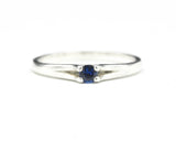 Round faceted blue sapphire ring in silver prongs setting