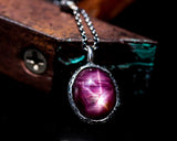 Oval deep red star ruby pendant necklace in silver bezel setting