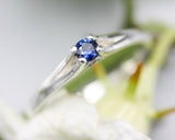 Round faceted blue sapphire ring in silver prongs setting