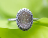 Brown oval druzy quartz ring in silver bezel setting with sterling silver texture band