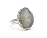 Oval light gray raw druzy ring in silver bezel setting with sterling silver texture band