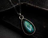 Labradorite pendant necklace in silver bezel setting with oval blue topaz secondary