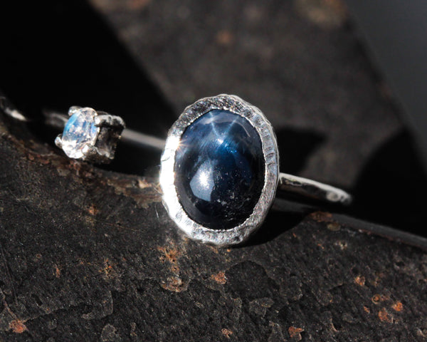 Oval blue star sapphire ring and tiny oval moonstone in silver bezel setting with sterling silver texture band