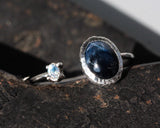 Oval blue star sapphire ring and tiny oval moonstone in silver bezel setting with sterling silver texture band