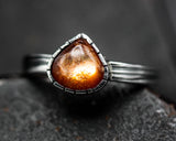 Teardrop tiny Sunstone ring in bezel setting with sterling silver oxidized texture band