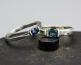 Wedding band set his and hers with blue sapphire gemstones