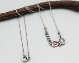 Moonstone, ruby and tiny garnet pendant necklace in silver bezel and prongs setting