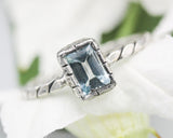 Rectangle blue topaz gemstone ring in silver bezel setting with sterling silver twist design band