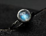 Round Moonstone ring in bezel setting with sterling silver twist design band
