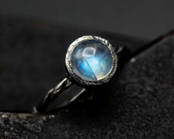 Round Moonstone ring in bezel setting with sterling silver twist design band