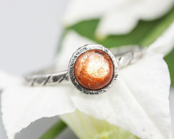 Round Sunstone ring in bezel setting with sterling silver oxidized twist design band