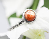 Round Sunstone ring in bezel setting with sterling silver oxidized twist design band