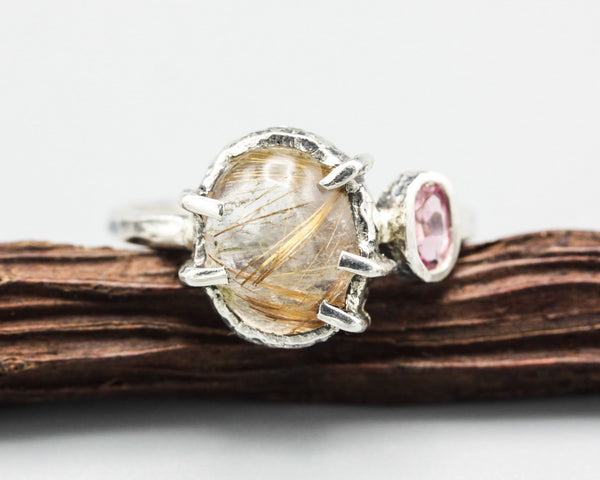 Oval golden rutilated quartz ring in silver bezel and prongs setting with pink tourmaline in sterling silver texture oxidized band