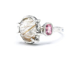Oval golden rutilated quartz ring in silver bezel and prongs setting with pink tourmaline in sterling silver texture oxidized band