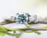 Sterling silver wedding ring with blue topaz, oval moonstone and tiny moonstone gemstone in bezel and prongs setting