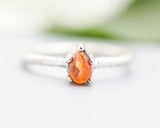 Teardrop cabochon Sunstone ring in prongs setting with sterling silver oxidized texture band