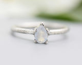 Teardrop faceted Moonstone ring in prongs setting with sterling silver oxidized texture band