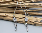 Oval moonstone earrings in silver bezel setting with silver sticks and hooks style on the top