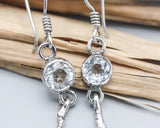 Round white topaz earrings in silver bezel setting with silver sticks and hooks style on the top