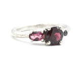 Sterling silver wedding ring with garnet, pink tourmaline and green tourmaline gemstone in bezel and prongs setting