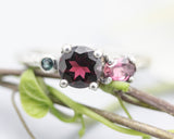 Sterling silver wedding ring with garnet, pink tourmaline and green tourmaline gemstone in bezel and prongs setting