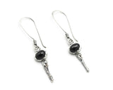 Oval Star Diopside Earrings, featuring a silver bezel setting and silver sticks and hooks on the top