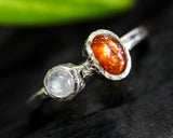 Sunstone ring in bezel setting with moonstone on sterling silver oxidized hammered texture band
