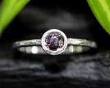 Round cut pink spinel ring in bezel setting with sterling silver texture band