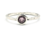 Round cut pink spinel ring in bezel setting with sterling silver texture band