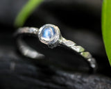 Round cabochon moonstone ring in bezel setting with sterling silver band