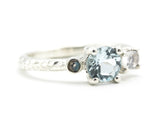 Sterling silver wedding ring with blue topaz, oval moonstone and tiny labradorite gemstone in bezel and prongs setting